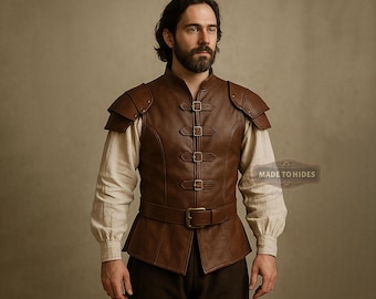 May include: A brown leather vest with shoulder pads and multiple buckle closures. The vest is worn over a cream-colored long-sleeved shirt. The vest has a belt around the waist. The overall style is reminiscent of historical or fantasy attire.