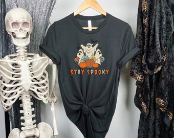 May include: Black t-shirt with a graphic of ghosts and pumpkins. The text "Stay Spooky" is printed below the graphic.