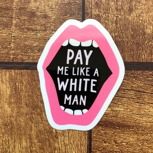 May include: A sticker featuring a stylized mouth with bright pink lips and white teeth. The mouth is open, revealing the text "PAY ME LIKE A WHITE MAN" in bold white letters against a black background. The sticker has a white border.