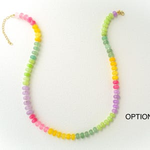 May include: A colorful beaded necklace with a gold-colored clasp. The necklace features a gradient of colors, including pink, yellow, green, and purple. The text "OPTION 3" is visible in the image.