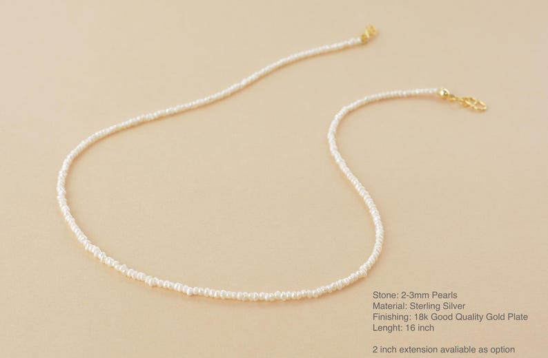 May include: A delicate white pearl necklace with a 16 inch length. The necklace is made of sterling silver and has a 18k gold plate finish. The pearls are 2-3mm in size. A 2 inch extension is available as an option.