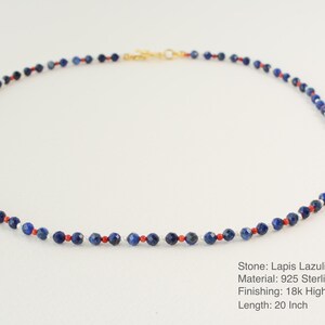 May include: A necklace made of lapis lazuli, coral, and pearl beads. The necklace is 20 inches long and is made of 925 sterling silver with an 18k gold plate finish.