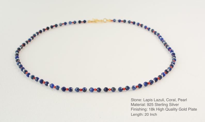 May include: A necklace made of lapis lazuli, coral, and pearl beads. The necklace is 20 inches long and is made of 925 sterling silver with an 18k gold plate finish.