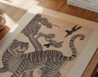 May include: An illustration featuring a tiger with black stripes and yellow eyes, a tree, and two birds. The artwork is in black and white with a beige background. The tiger is the focal point, with a detailed depiction of its fur and facial expression.