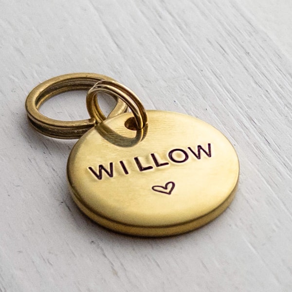 Brass Metal Dog Tag with Heart Hand Stamped with Your Pets Name on Front and Personalized with Your Phone Number on the back.
