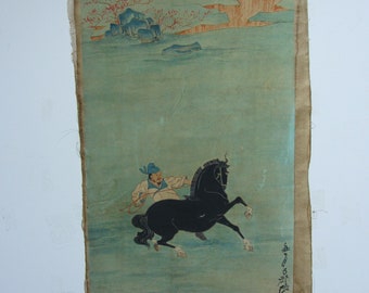 May include: An antique Asian painting on aged paper. The artwork depicts a figure on a rearing black horse, set against a backdrop of a serene landscape with mountains and flowering trees. The painting has Japanese characters.
