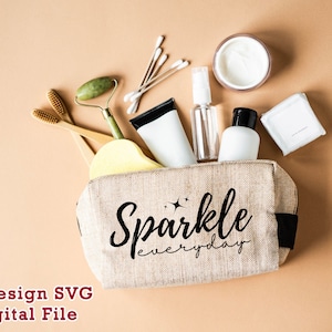 May include: A beige cosmetic bag with the words "Sparkle everyday" in black script, filled with beauty products. Items include a jade roller, toothbrushes, cotton swabs, and various white bottles and jars. The words "14 design SVG Digital File" are at the bottom.