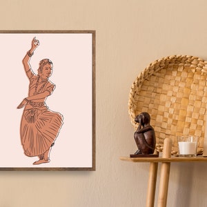 May include: A framed illustration of a woman in a traditional Indian dance pose, wearing a long skirt and jewelry. The illustration is in shades of brown and pink on a white background.