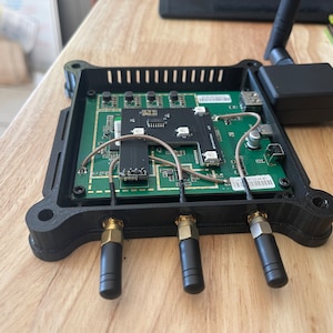 May include: A black router with four antennas and a green circuit board inside. The router has a USB port and a label that says "AP 0234 AC".
