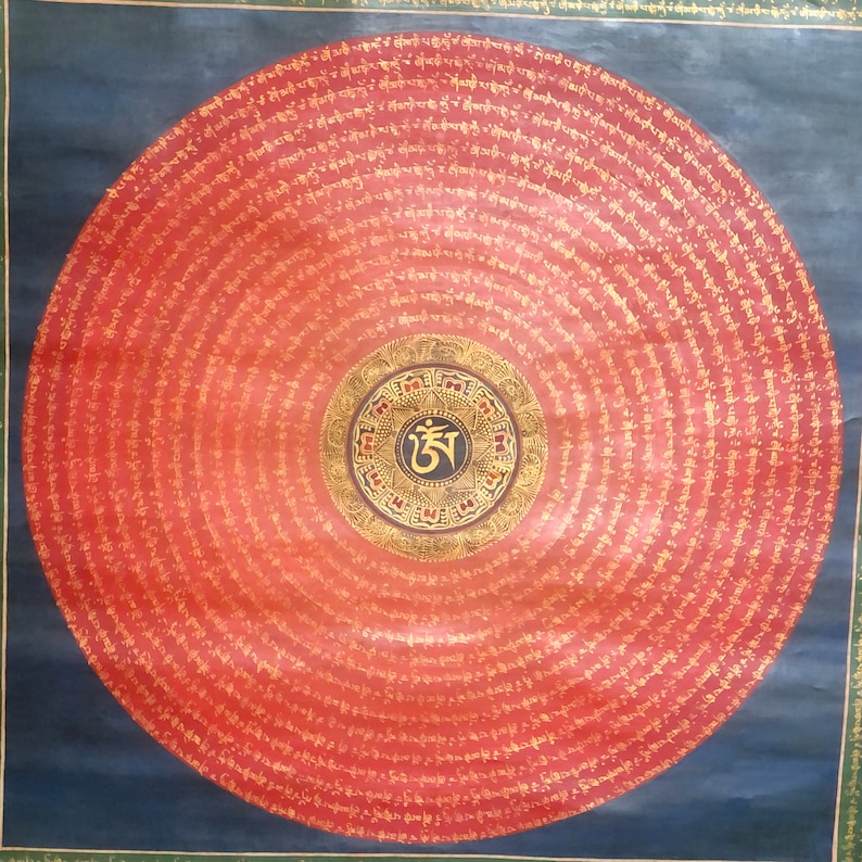 Puede incluir: Un mandala circular con fondo rojo y letras doradas. El centro del mandala presenta un c&iacute;rculo negro con un s&iacute;mbolo dorado y un borde dorado. El mandala est&aacute; rodeado de c&iacute;rculos conc&eacute;ntricos de letras doradas.