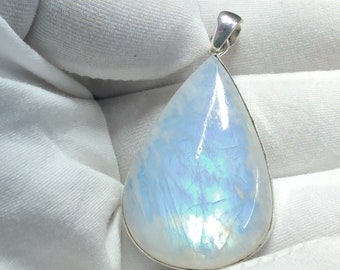May include: A teardrop-shaped pendant made of white moonstone with a silver bail. The moonstone has a shimmering iridescent effect.