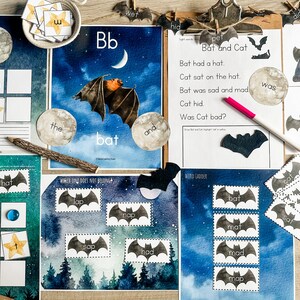 May include: A set of educational printable worksheets for kids featuring a bat theme. The worksheets include a word ladder, a sight word activity, a matching game, and a 'which one does not belong' activity. The worksheets are printed on white paper with a watercolor background.