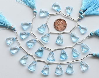 May include: A strand of light blue topaz gemstone beads with silver spacers and tassels. The beads are faceted and have a teardrop shape. The strand is approximately 18 inches long.