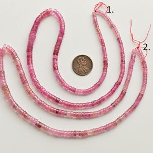 May include: Three strands of pink tourmaline beads, each strand is approximately 18 inches long. The beads are faceted and have a square shape. A US penny is included for size reference.