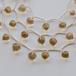 May include: A silver chain necklace with multiple strands and dangling faceted smoky quartz stones.