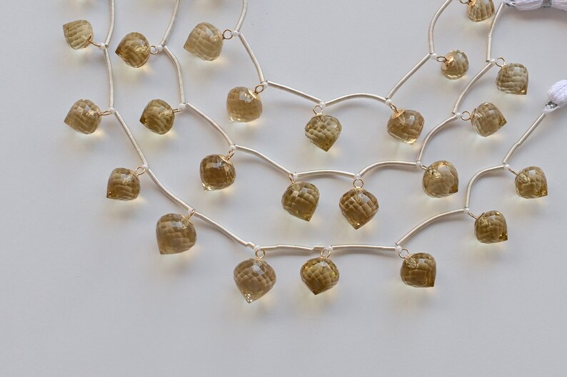 May include: A silver chain necklace with multiple strands and dangling faceted smoky quartz stones.