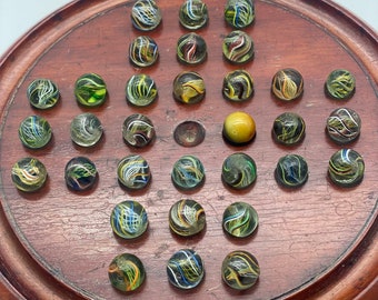 Antique solitaire board with 31 hand made antique marbles with Pontil marks, one marble without.