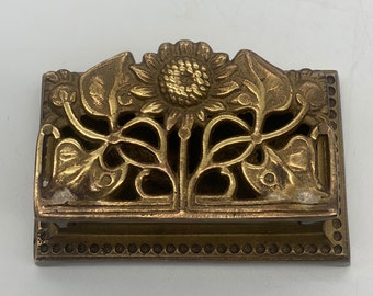 Vintage brass stamp storage box with floral cut out pattern in the lid. Width 8cm.