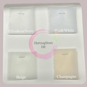 May include: Four fabric swatches in a white plastic tray. The swatches are labeled "Elfenbein/Ivory", "Weiß/White", "Beige", and "Champagne".