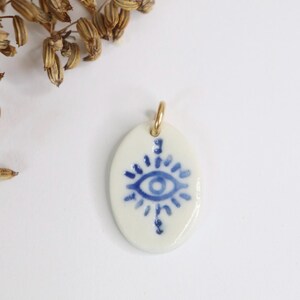 1 pendentif artisanal en porcelaine bleu blanc mauvais œil en céramique