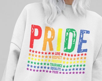 May include: White sweatshirt with the word "PRIDE" in rainbow colors. The word is surrounded by rows of stars in rainbow colors. Below the word are the words "LOVE", "RESPECT", "FREEDOM", "TOLERANCE", "EQUALITY", and "PRIDE" in black text.