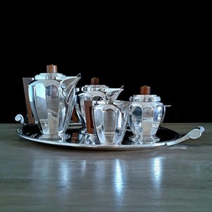 Roux-Marquiand Lyon, 5 Piece Tea And Coffee Service, 20th Century Art-Deco with Solid Wood and Silverplate Cira 1930s.