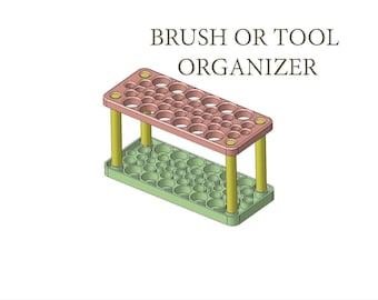 May include: A two-tiered brush or tool organizer with a green base and a pink top. The organizer has multiple round holes of varying sizes to hold brushes or tools.