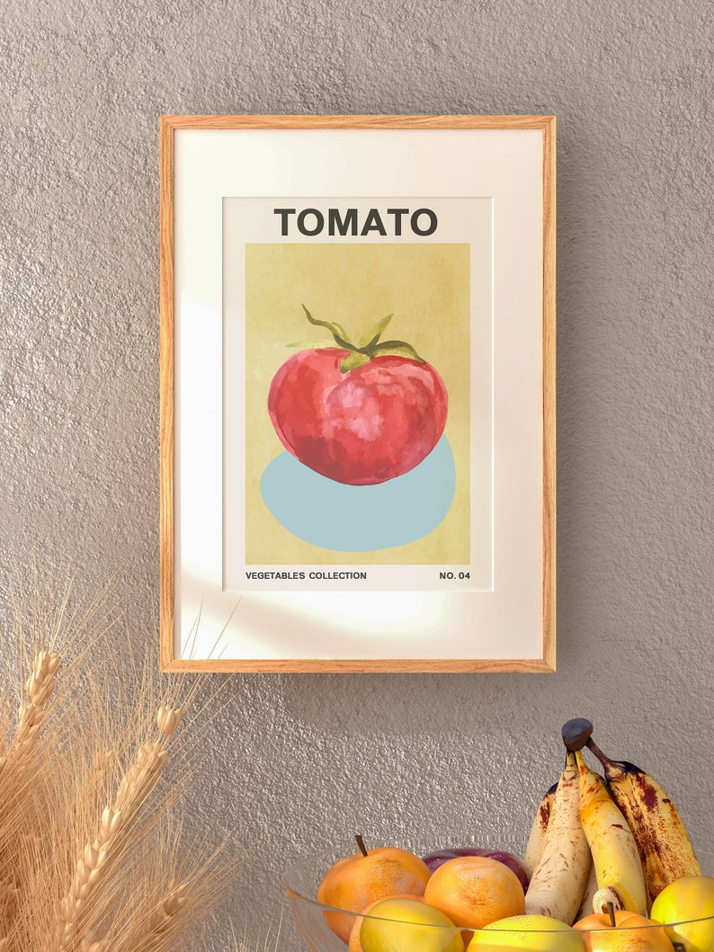 May include: A framed print of a red tomato with a green stem and leaves on a light yellow background. The print is titled "TOMATO" and is part of a "VEGETABLES COLLECTION" with the number "NO. 04" printed below the image.