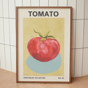 May include: A framed poster with a watercolor illustration of a red tomato on a light blue background. The poster has the word "TOMATO" in black text at the top and "VEGETABLES COLLECTION NO. 04" in black text at the bottom.