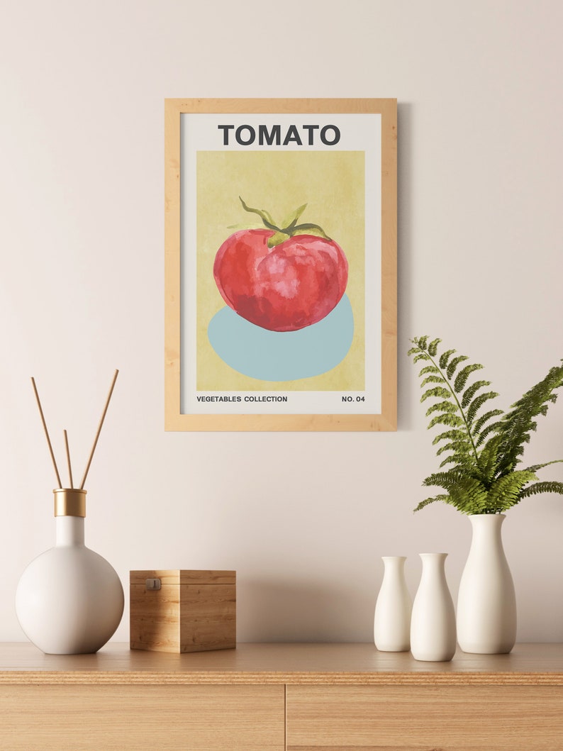 May include: A framed print of a red tomato with a green stem on a light blue background. The print is titled "TOMATO" and is part of a "VEGETABLES COLLECTION" with the number "NO. 04".