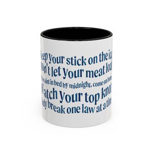 May include: White ceramic coffee mug with a black rim. The mug has a blue and white text design that reads "Keep your stick on the ice, Don't let your meat load, If you ain't in bed by midnight, come on home, Watch your top knot, Only break one law at a time."