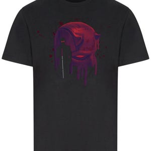 Może przedstawiać: Czarny T-shirt z czerwono-fioletowym nadrukiem głowy superbohatera, z którego kapie krew.