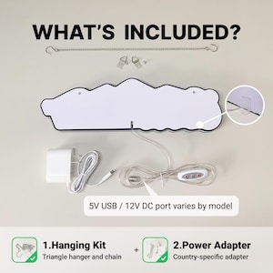 May include: A white sign with a black outline, a metal hanging chain, two triangle hangers, and a power adapter with a cord featuring a control switch. Text reads WHAT'S INCLUDED?, 5V USB / 12V DC port varies by model, 1.Hanging Kit, and 2.Power Adapter.