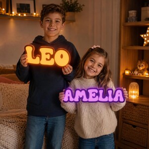 May include: Two custom LED signs featuring the names LEO in a warm orange glow and AMELIA in a vibrant purple light. Each sign is crafted in a bold, rounded font style with a distinct illuminated outline, creating a bright and clear display.