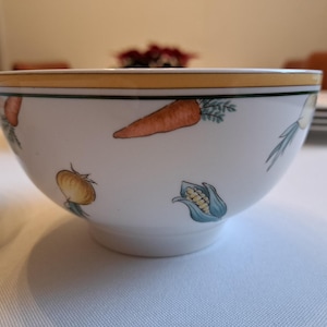 May include: Two white ceramic bowls with a yellow rim and a vegetable design. The bowls feature carrots, onions, and corn.