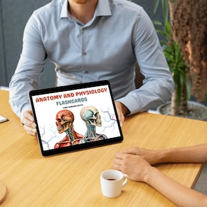 May include: A digital tablet displaying a cover for Anatomy and Physiology Flashcards for future nursing notes. The cover features two illustrations of human skulls with red and blue veins.