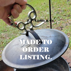 May include: A close-up of a cast iron pot lid with a metal handle. The lid is sitting on top of a black pot. The text "MADE TO ORDER LISTING." is printed on the lid. The metal handle has a decorative design and the text "Z.P. Liollo & Co." is printed on the handle.