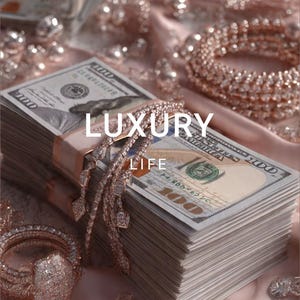 May include: A stack of hundred-dollar bills with a diamond bracelet and other jewelry. The word "LUXURY LIFE" is written across the image. The background is a soft pink fabric.