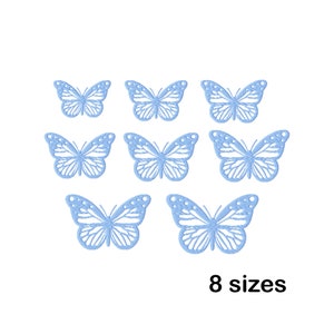 May include: Eight blue butterfly cutouts in various sizes. The butterflies are arranged in a symmetrical pattern.