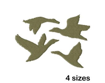 May include: Four green silhouette geese flying in a V formation. The geese are outlined in a textured fabric. The text "4 sizes" is below the geese.