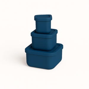 May include: Three navy blue square food storage containers stacked on top of each other. Each container has a matching lid. The containers are different sizes, with the largest at the bottom and the smallest at the top.