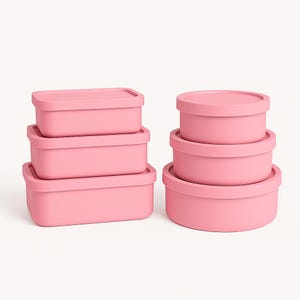 May include: A set of pink food storage containers in various sizes. The containers are rectangular and round, with matching lids. The containers are stacked in groups of three and four, and are made of a solid, matte material.