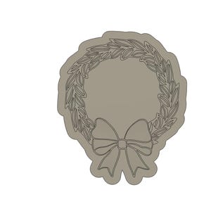 May include: A brown wreath with a simple bow in the center. The wreath is made of leaves and the bow is white.