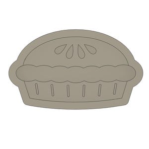Könnte beinhalten: Ein hellbrauner Ausstecher in Form eines Kuchens. Der Ausstecher hat die Form eines Kuchens mit gewelltem Rand und dekorativer Oberseite. Der Kuchen hat eine abgerundete Oberseite und eine rechteckige Basis mit vertikalen Linien.