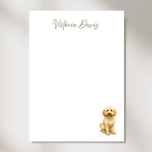 May include: White stationery with the name "Victoria Davis" in green script at the top. A watercolor illustration of a golden doodle dog sits at the bottom. The stationery is perfect for personalized notes.