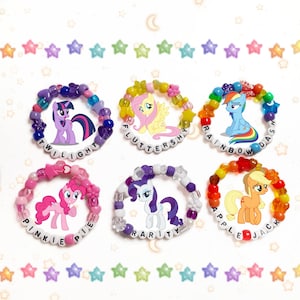 May include: Six colorful beaded bracelets with My Little Pony characters and names: Twilight Sparkle, Fluttershy, Rainbow Dash, Pinkie Pie, Rarity, and Applejack.