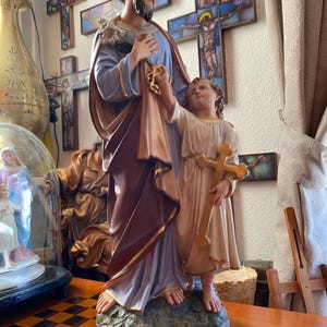 Large old sculpture of Joseph with baby Jesus and lily flower. 60 cm high, 25 inches. Religious (statue) sculpture. Minor signs of age.