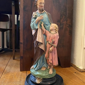 Large old sculpture, image of Joseph, with baby Jesus and lily flower. 45 cm high. Religious (statue) sculpture. Traces of age are certainly present.