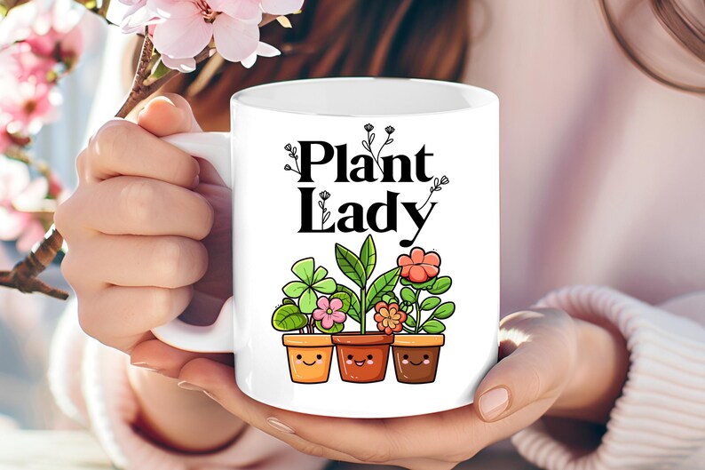 Peut inclure: Une tasse en c&eacute;ramique blanche avec un motif noir qui dit "Plant Lady" et repr&eacute;sente trois plantes en pot avec des visages souriants.
