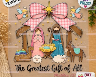 May include: A DTF transfer sheet featuring a nativity scene with a pink gingham bow, angels, a camel, a donkey, sheep, and a manger. The text reads The Greatest Gift of All and Matthew 1:21. The design includes a yellow star and small stars.